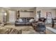Cozy living room with dark leather furniture, decor, and views of other living spaces at 1177 Jamaica St, Aurora, CO 80010