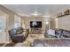 Spacious living room featuring hardwood floors and plenty of natural light at 1177 Jamaica St, Aurora, CO 80010