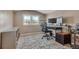 Bright office space with plush carpeting, natural light, and monitor setup at 1177 Jamaica St, Aurora, CO 80010