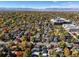 Expansive aerial view of a neighborhood filled with mature trees and houses near the Rocky Mountains at 3317 W 37Th Ave, Denver, CO 80211