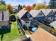 Aerial view of backyard featuring patio, green lawn, and mature trees at 3317 W 37Th Ave, Denver, CO 80211