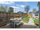Fenced backyard with patio, dining set, and grass area perfect for entertaining at 3317 W 37Th Ave, Denver, CO 80211