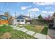 Landscaped backyard featuring a patio area with seating and stone walkway at 3317 W 37Th Ave, Denver, CO 80211