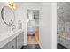 Modern bathroom featuring vanity with sink, geometric tile, and access to bedroom at 3317 W 37Th Ave, Denver, CO 80211