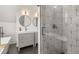 Modern bathroom featuring double vanity, stylish tile shower, and sleek fixtures at 3317 W 37Th Ave, Denver, CO 80211