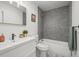 Modern bathroom with a mosaic tile accent wall, and sleek white vanity at 3317 W 37Th Ave, Denver, CO 80211