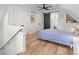 Well-lit bedroom featuring wood floors, closet space, and a doorway to the bathroom at 3317 W 37Th Ave, Denver, CO 80211