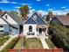 Charming blue two-story home with a well-manicured front yard and inviting front porch at 3317 W 37Th Ave, Denver, CO 80211