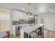 Bright and modern kitchen featuring stainless steel appliances and a large island with bar seating at 3317 W 37Th Ave, Denver, CO 80211