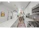 Spacious kitchen with a marble island, stainless steel appliances, and view into the modern living area at 3317 W 37Th Ave, Denver, CO 80211