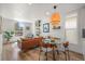 Open-concept living space with modern décor, hardwood floors, and a light-filled dining area at 3317 W 37Th Ave, Denver, CO 80211