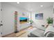 Cozy living room featuring a comfortable gray sofa, flat screen TV, and modern decor at 3317 W 37Th Ave, Denver, CO 80211