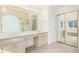 Bathroom with double sinks, vanity, and mirrored closet at 5485 S Jasper Ct, Centennial, CO 80015
