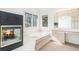 Bathroom with a fireplace, tub, and vanity with a large mirror at 5485 S Jasper Ct, Centennial, CO 80015