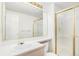 Clean bathroom with a white sink, gold fixtures, a large mirror, and a glass-enclosed shower at 5485 S Jasper Ct, Centennial, CO 80015