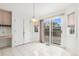 Cozy dining area with tile flooring, a sliding glass door to the deck, and a vintage chandelier at 5485 S Jasper Ct, Centennial, CO 80015