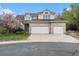 Charming two-story brick home featuring an attached three-car garage and a well-maintained front yard at 5485 S Jasper Ct, Centennial, CO 80015