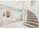 Grand foyer with a curved staircase, tile flooring, and views into the living room at 5485 S Jasper Ct, Centennial, CO 80015