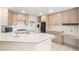Bright kitchen with tile countertops, built-in appliances, ample cabinet space, and an adjacent desk area at 5485 S Jasper Ct, Centennial, CO 80015
