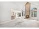 Spacious living room with vaulted ceilings and a brick fireplace, connected to the kitchen area at 5485 S Jasper Ct, Centennial, CO 80015