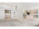 Open-concept living room featuring a bar area, a brick fireplace, and views of the upper-level balcony at 5485 S Jasper Ct, Centennial, CO 80015