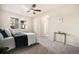 Bright bedroom with plush carpeting, a ceiling fan, and windows providing natural light at 11213 Colony Cir, Broomfield, CO 80021