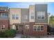Modern townhome with brick and siding, featuring large windows and a pergola over the entrance at 11213 Colony Cir, Broomfield, CO 80021