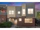 Modern townhouse exterior with brick accents and a pergola over the entryway, inviting curb appeal at 11213 Colony Cir, Broomfield, CO 80021