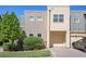 Exterior of a modern townhome featuring a front garage, a tree and a small lawn at 11213 Colony Cir, Broomfield, CO 80021