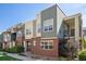 Modern townhome with a combination of brick, siding, and large windows at 11213 Colony Cir, Broomfield, CO 80021