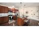 Updated kitchen with granite countertops, stainless steel appliances, and center island seating at 11213 Colony Cir, Broomfield, CO 80021