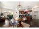 Open-concept living room and kitchen with hardwood floors, modern lighting, and stainless steel appliances at 11213 Colony Cir, Broomfield, CO 80021