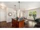 Kitchen and living room with a center island, wood floors, and plenty of natural light at 11213 Colony Cir, Broomfield, CO 80021