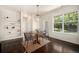 Dining area featuring modern light fixture, wood floors, and lots of natural light from the windows at 11213 Colony Cir, Broomfield, CO 80021