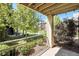 Outdoor patio with serene views of a courtyard and mature trees at 11213 Colony Cir, Broomfield, CO 80021