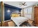 Stylish bedroom featuring a statement headboard, decorative pillows, and a ceiling fan with lots of natural light at 4878 E Kentucky Ave # B, Denver, CO 80246