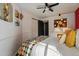 Bright bedroom features wood floors, ceiling fan, large closet, and accent wall at 4878 E Kentucky Ave # B, Denver, CO 80246