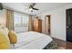 Bright bedroom features wood floors, modern ceiling fan and a large window for natural light at 4878 E Kentucky Ave # B, Denver, CO 80246