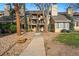 Inviting multi-story condo with well-maintained landscaping and a charming walkway to the entrance at 4878 E Kentucky Ave # B, Denver, CO 80246