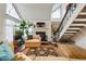 Bright living room with fireplace, large windows, stairs and stylish decor at 4878 E Kentucky Ave # B, Denver, CO 80246