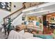 Comfortable living room with a view into the kitchen and a staircase at 4878 E Kentucky Ave # B, Denver, CO 80246