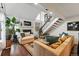Cozy living room featuring a fireplace, comfortable seating, and hardwood floors with abundant natural light at 4878 E Kentucky Ave # B, Denver, CO 80246