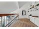 Upstairs loft featuring white walls, a desk area, and built-in shelving at 4878 E Kentucky Ave # B, Denver, CO 80246