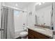 Bright bathroom showcasing a shower and tub combination, granite countertops, and a modern vanity at 10152 Xanadu St, Commerce City, CO 80022