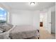 A cozy bedroom showcasing natural light, a neutral color palette, and convenient access to the bathroom at 10152 Xanadu St, Commerce City, CO 80022