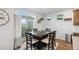Cozy dining area with a modern dark wood dining table and chairs, adjacent to a sliding glass door at 10152 Xanadu St, Commerce City, CO 80022