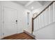 Bright entryway features wood floors, stairs, and white walls with a decorative mirror at 10152 Xanadu St, Commerce City, CO 80022