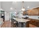 Spacious kitchen with granite countertops, stainless appliances, pendant lighting, and an open view to the dining area at 10152 Xanadu St, Commerce City, CO 80022