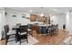 Open concept kitchen features a large island, modern lighting, stainless steel appliances, and hardwood floors at 10152 Xanadu St, Commerce City, CO 80022
