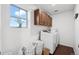 Bright laundry room equipped with modern appliances and ample storage space in a stylish and functional home at 10152 Xanadu St, Commerce City, CO 80022